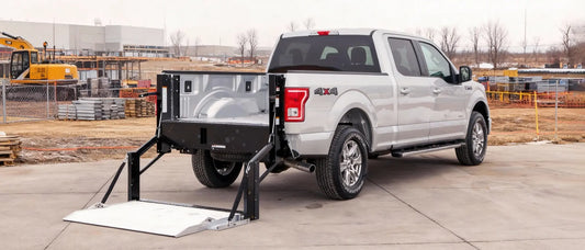 Hydraulic truck liftgate lowering heavy cargo from truck bed to ground level during delivery
