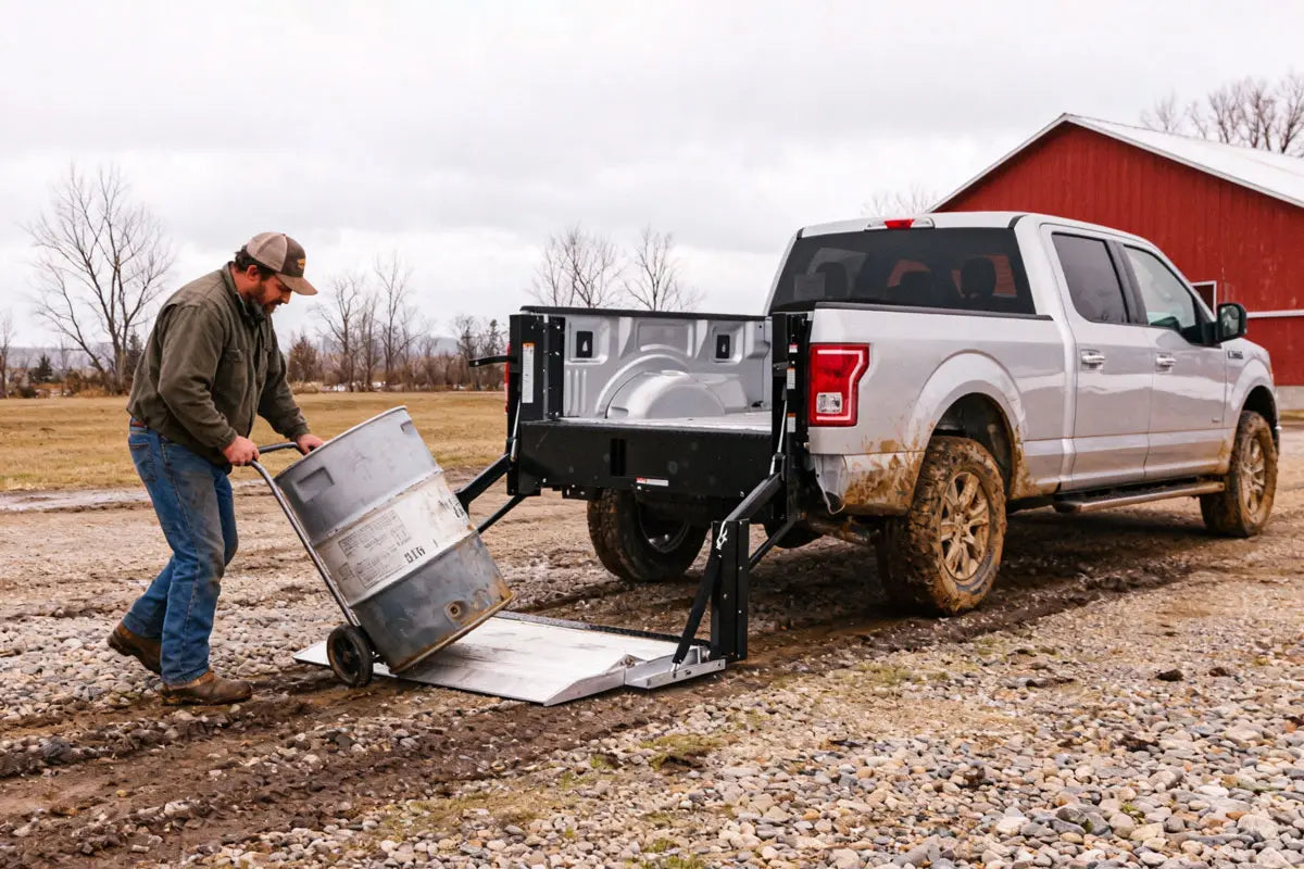 Farmer loading feed bags and seed onto a pickup truck using an aluminum hydraulic liftgate in rural Canada
