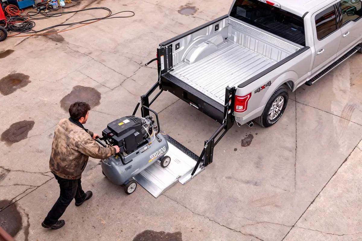 Contractor lifting generator and job-site tools into a pickup truck using an aluminum hydraulic liftgate